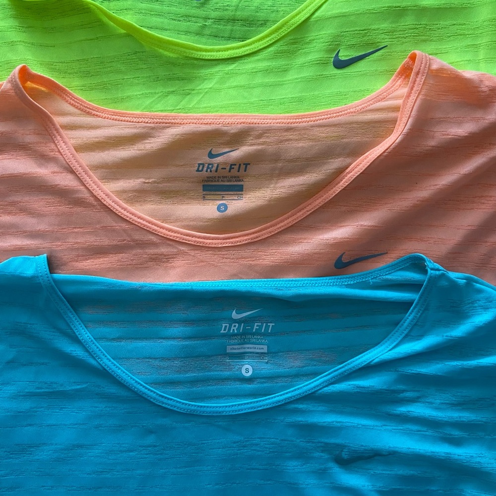 Nike workout tees. Size small. There is blue, yellow, and peach